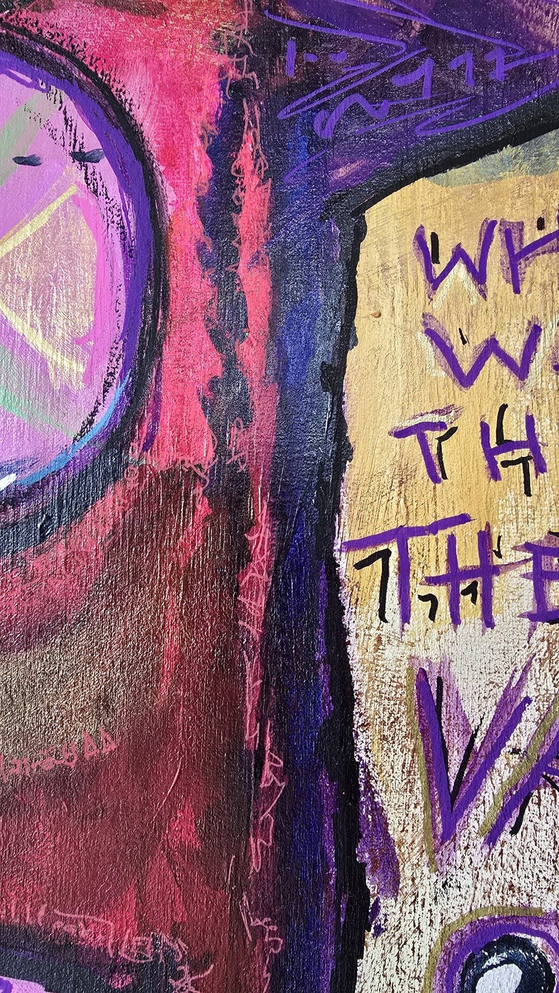 Close-up of the pink horns, purple cross, and one of the demon's magenta cross-X eyes against the red face and dark right edge.