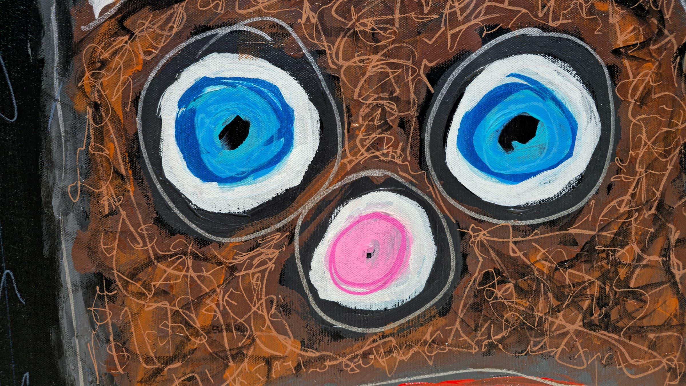 Close-up of the eyes and nose of Feral Freq: two large round eyes with blue-and-white irises, black pupils and charcoal-grey rings set in the brown paint-pen-scribbled fur, with a small pink-and-white roundel nose below and between them.